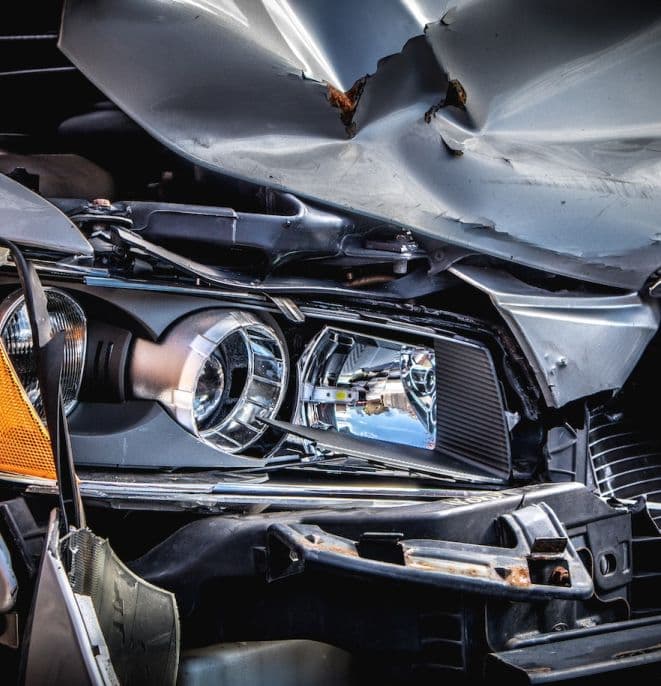 Crushed front of a grey car | Automobile Accidents | The Sullivan Law Firm