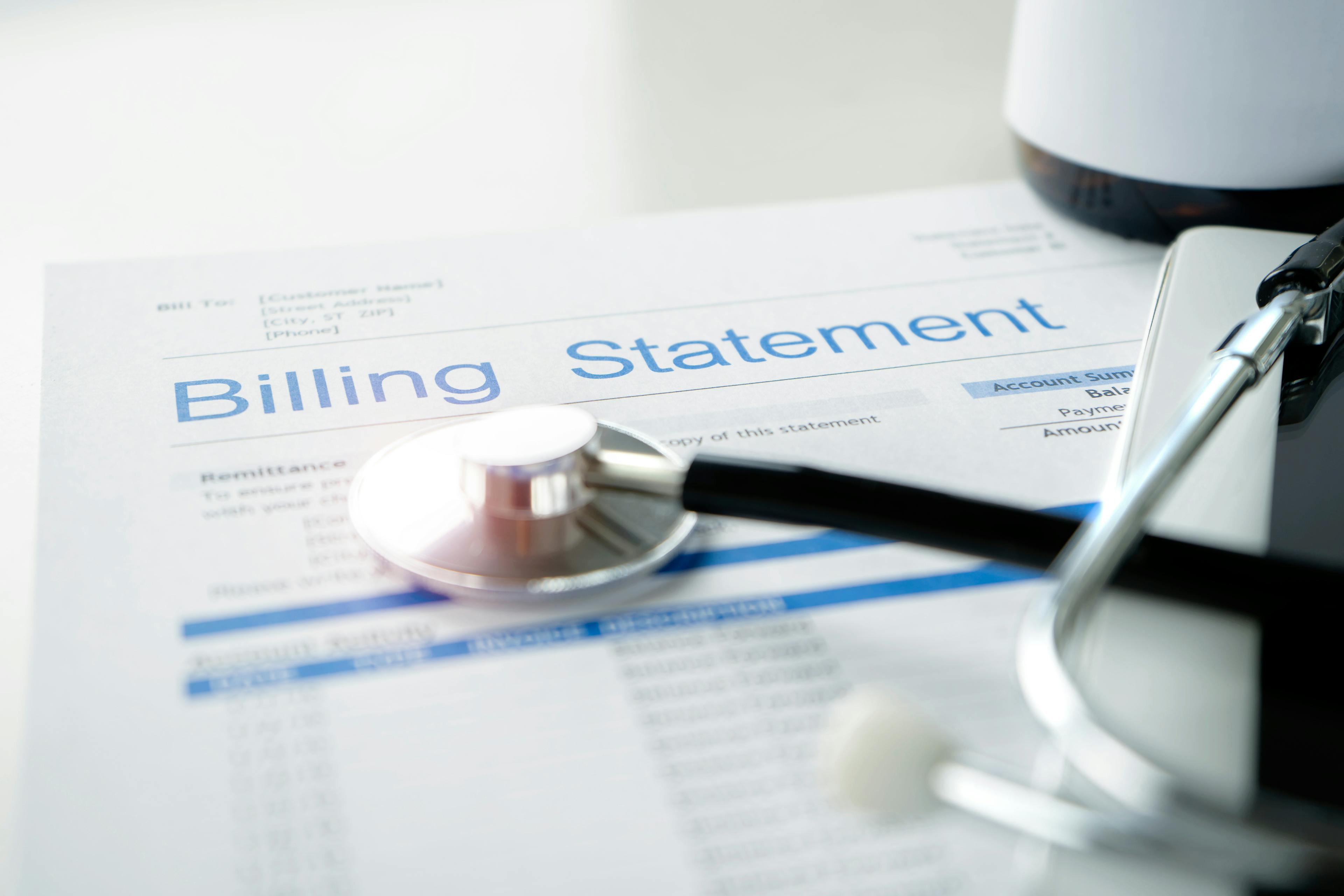 Hospital billing statement with a stethoscope resting on top of it | Medical Treatment | The Sullivan Law Firm